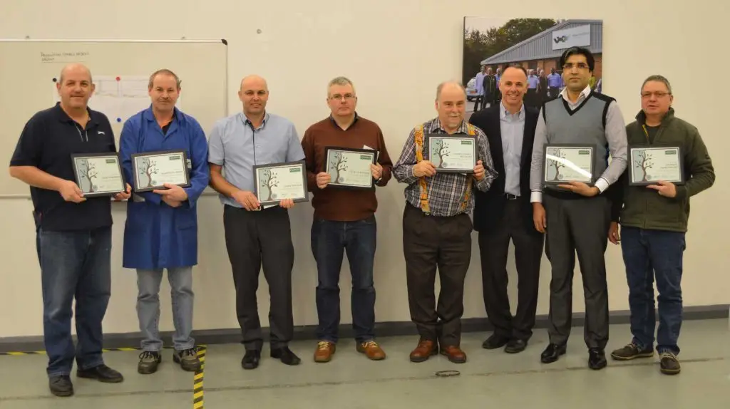 Pictured L to R: Nick Edwards (40 years); Martin Purser (20 years); John Wilson (25 years); Dave Turnbull (15 years); Chris Clarke-Williams (35 years); Shoaib Idrees (5 years); and Patrick Mortimore (10 years). Andrew Marcou, Crowley Company CFO (third from right), presented plaques and gifts during a recent visit. 