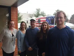 Crowley employees Angela Terrant, Cassie Hahn, Daniel Cocci, Tanya French and Andrew Morris pose in front of the Red Cross bloodmobile during Monday's blood drive. 