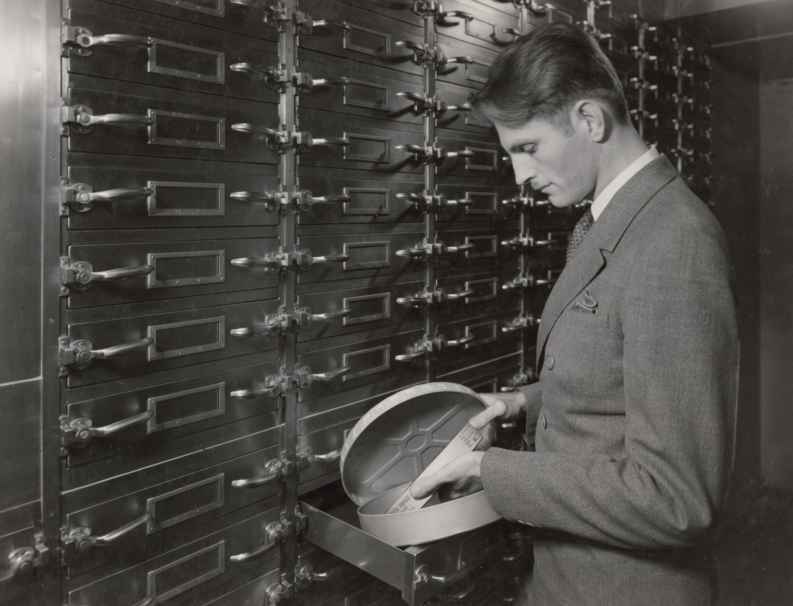 Glenn C. Henry of the Division of Motion Pictures and Sound Recordings in film storage area